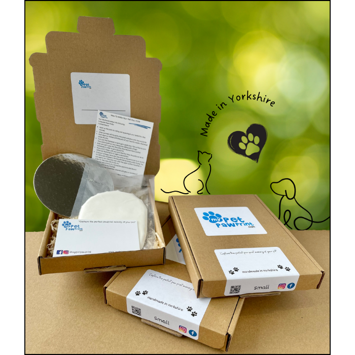 Three paw print kits. One Open showing contents and two closed