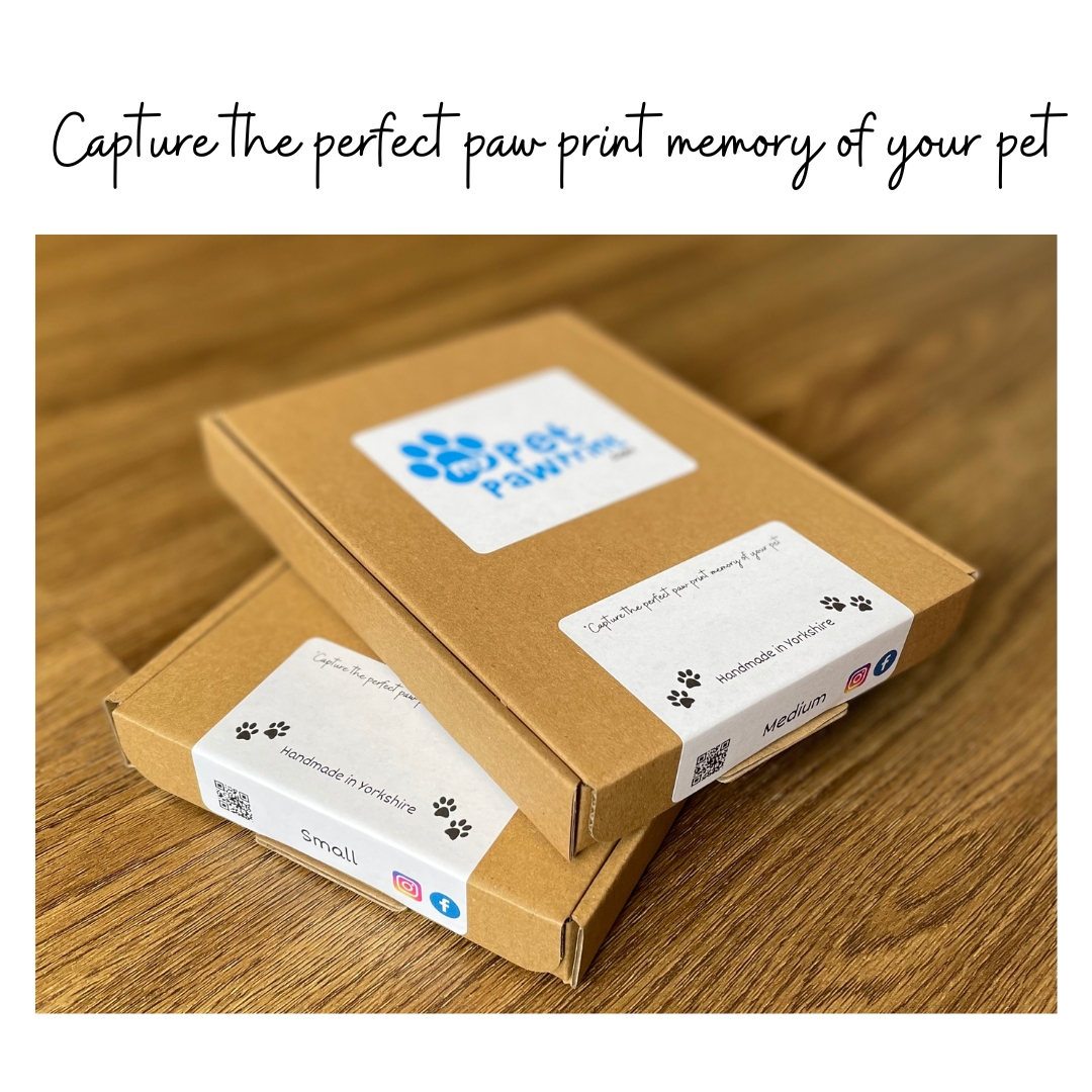 Two closed, sealed paw print kits with tag line capture the perfect paw print memory of your pet